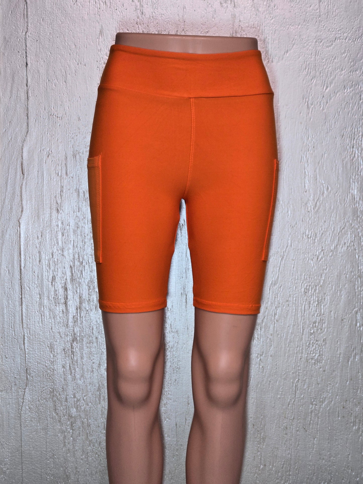 Orange capris and biker shorts with pockets